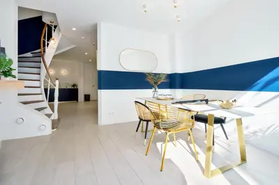 a dining room with a table and chairs at Urban Walls in Brussels