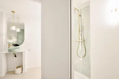 a bathroom with a shower with a glass door at Urban Walls in Brussels
