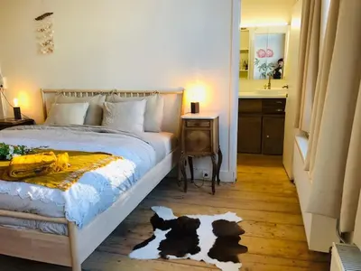 a bedroom with a bed with a rug with dogs on it at Logies Lapin in Antwerp