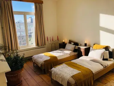 a bedroom with two beds and a window at Logies Lapin in Antwerp