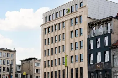 a tall building with many windows on a city street at B&B HOTEL Antwerpen Centrum in Antwerp