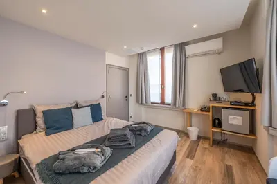 a bedroom with a bed and a flat screen tv at Hotel Fi'Lin in Machelen