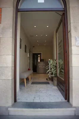 an entrance to a store with a bench in a window at Hotel Fi'Lin in Machelen