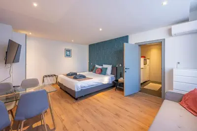 a bedroom with a bed and a table and chairs at Hotel Fi'Lin in Machelen