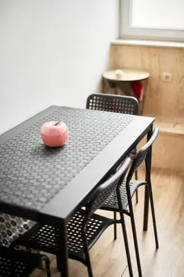a black table with chairs and a pink ball on it at BoLofts in Antwerp