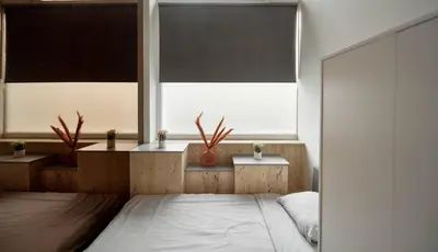 a bedroom with a bed and two windows at BoLofts in Antwerp