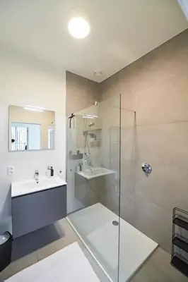 a bathroom with a sink and a glass shower at BoLofts in Antwerp