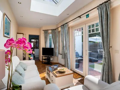 a living room with white couches and a tv at Villa Jasmine by Interhome in Mol