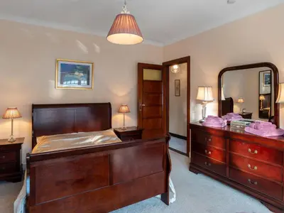 a bedroom with a bed and a dresser and a mirror at Villa Jasmine by Interhome in Mol