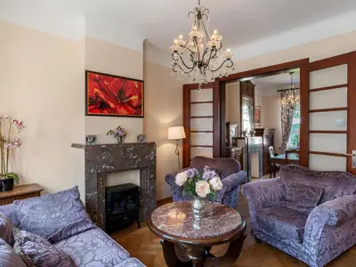 a living room with purple furniture and a fireplace at Villa Jasmine by Interhome in Mol