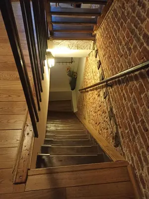 a staircase in a building with a brick wall at Cosy Nest in Historical Center in Brussels
