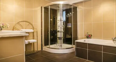 a bathroom with a shower and a tub and a sink at Cosy Nest in Historical Center in Brussels