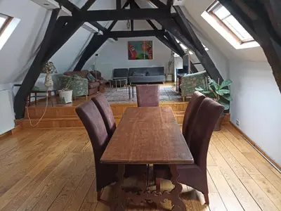 a dining room with a wooden table and chairs at Cosy Nest in Historical Center in Brussels