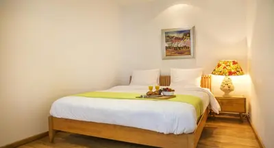a bedroom with a bed with a tray of food on it at Cosy Nest in Historical Center in Brussels