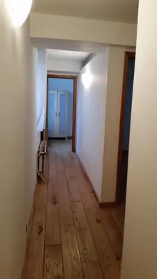 an empty hallway with a wooden floor in a room at Cosy Nest in Historical Center in Brussels
