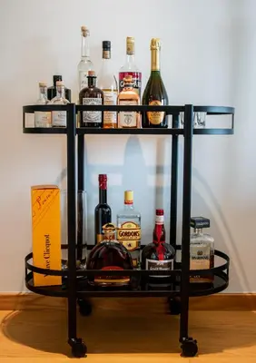 a drink cart with bottles of alcohol on it at Scheldeoever in Temse