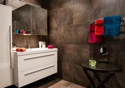 a bathroom with a white sink and a table at Scheldeoever in Temse