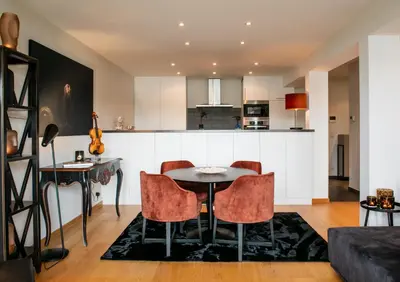 a kitchen and living room with a table and chairs at Scheldeoever in Temse