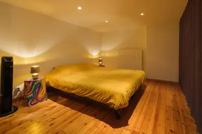 a bedroom with a large bed in a room at Duplex in historical centre with private courtyard in Antwerp