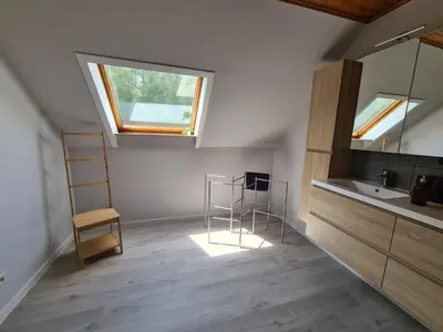 a bathroom with a sink and a mirror and a window at Tussenbeke in Lede