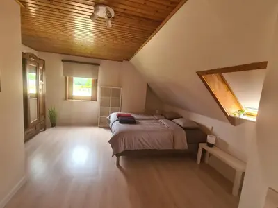 a bedroom with a bed in a attic at Tussenbeke in Lede