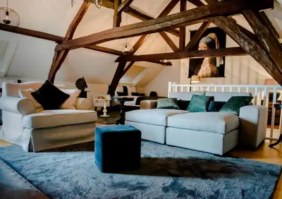 a living room with two couches and a blue rug at Huis Bertem in Bertem