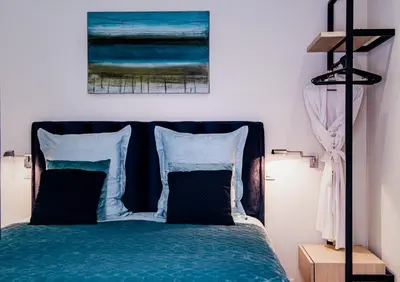 a bedroom with a bed with a painting on the wall at Huis Bertem in Bertem
