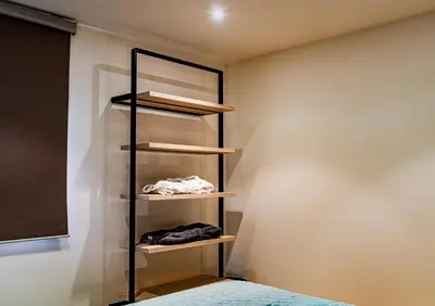a closet with wooden shelves and a bed at Huis Bertem in Bertem