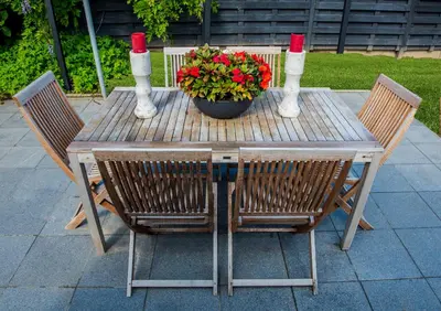 a wooden table with two chairs and a pot of flowers at Huis Bertem in Bertem