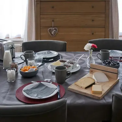 a table with a table cloth with cheese and food on it at Wellintown Guest House in Waterloo