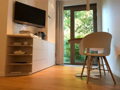 a kitchen with a desk and a chair and a tv at Het Nekkerhof B&Bio in Mechelen