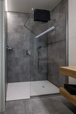 a bathroom with a shower with a glass door at Bleekhoeve in Olen