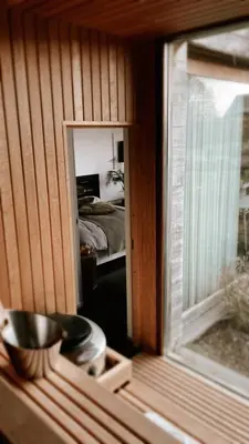 a room with a mirror and a room with a bed at Lit de Clémot in Merelbeke