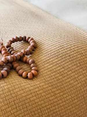 a group of brown bead bracelets on a blanket at Lit de Clémot in Merelbeke