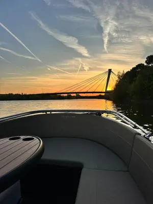 a boat on the water with a bridge in the background at Lit de Clémot in Merelbeke