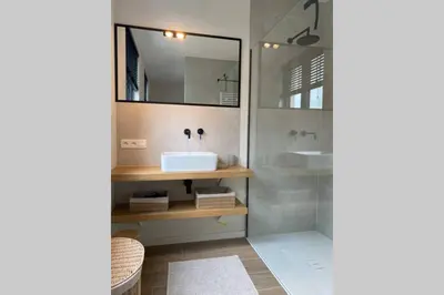 a bathroom with a sink and a shower at Schitterend nieuwbouw appartement in Gent in Ghent