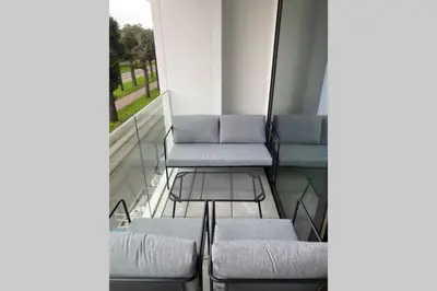 a balcony with chairs and a table on a building at Schitterend nieuwbouw appartement in Gent in Ghent