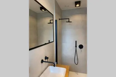 a bathroom with a sink and a shower at Schitterend nieuwbouw appartement in Gent in Ghent