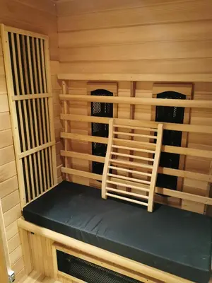 a sauna with a bench in a wooden cabin at Mica beauty & wellness center in Temse