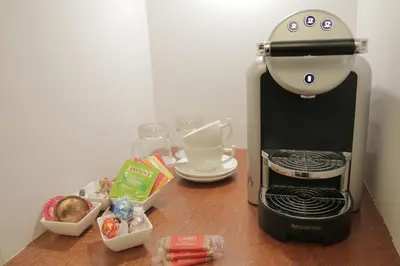a coffee maker sitting on top of a wooden table at Art de Sejour - B&B in Brussels