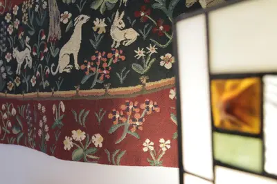 a curtain with a floral pattern on it next to a window at Art de Sejour - B&B in Brussels