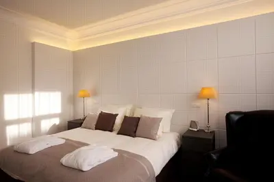 a bedroom with a large bed with two lamps at Art de Sejour - B&B in Brussels