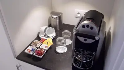a coffee maker on a counter in a refrigerator at Art de Sejour - B&B in Brussels