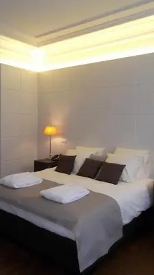 a bedroom with a large bed with white sheets and pillows at Art de Sejour - B&B in Brussels