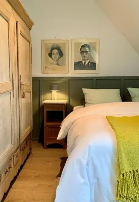 a bedroom with a bed and two pictures on the wall at b&b Meilrijk in Diest