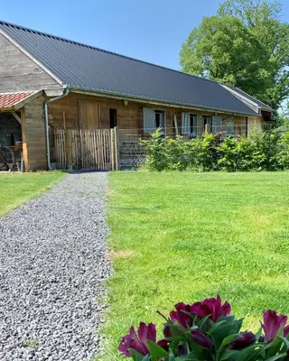 a house with a gravel driveway in front of a yard at b&b Meilrijk in Diest