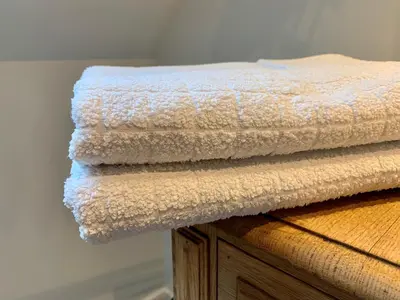 a stack of towels sitting on top of a dresser at b&b Meilrijk in Diest