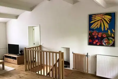 a living room with a painting on the wall at Charming house in the woods with private wellness in Schilde