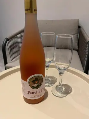 a bottle of beer sitting on a table with two wine glasses at Charming modern apartment in the heart of Antwerp with optional private parking in Antwerp