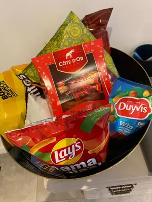 a bowl filled with chips and other snacks on a counter at Charming modern apartment in the heart of Antwerp with optional private parking in Antwerp